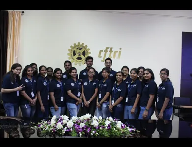 Students of the Integrated M.Sc.–Ph.D. programme in matching uniforms, in front of the CFTRI logo